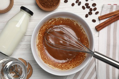 Photo of Whipping cream from instant coffee granules and ingredients on white wooden table, flat lay