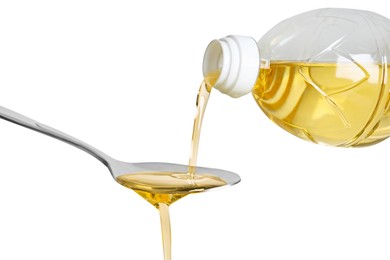 Photo of Pouring cooking oil from bottle into spoon on white background, closeup