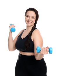 Happy overweight woman doing exercise with dumbbells on white background