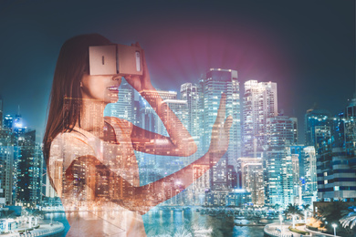 Double exposure of woman using virtual reality headset and cityscape. Modern technology