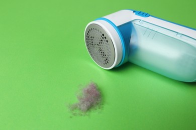 Modern fabric shaver and lint on green background