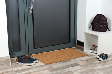 Hallway interior with shoes, backpack and mat near door