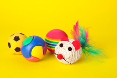 Various bright pet toys on yellow background