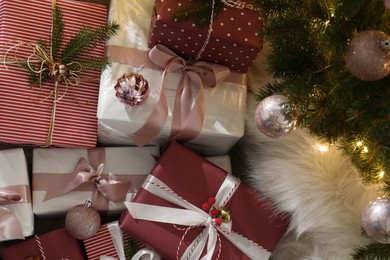 Photo of Gift boxes under Christmas tree, above view