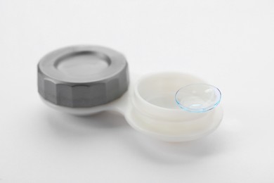 Photo of Case with contact lens on white background, closeup