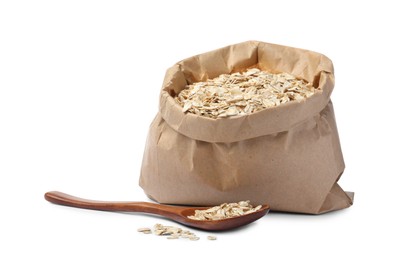 Raw oatmeal, paper bag and wooden spoon on white background