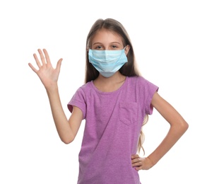 Little girl in protective mask showing hello gesture on white background. Keeping social distance during coronavirus pandemic