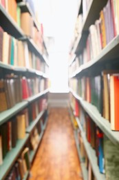 Blurred view of books on shelves in library