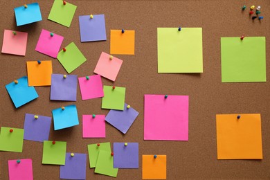 Many blank colorful notes pinned to corkboard
