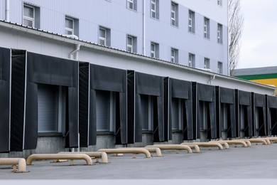 Warehouse with loading docks outdoors. Logistics center