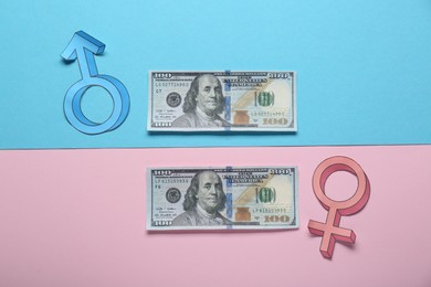 Photo of Gender pay gap. Male and female symbols with dollar banknotes on color background, flat lay