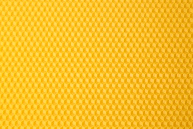 Photo of Natural beeswax sheet as background, top view