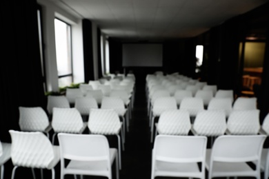Photo of Blurred view of empty modern conference hall