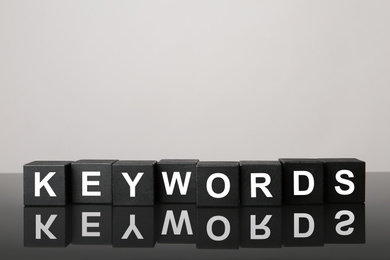 Black cubes with word KEYWORDS on light grey background