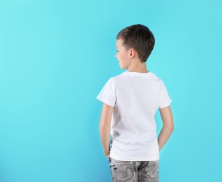 Little boy in t-shirt on color background. Mock-up for design