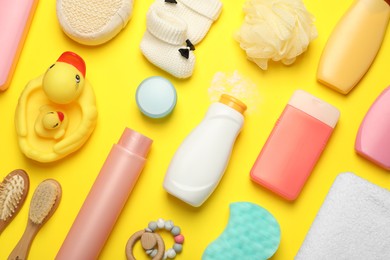 Flat lay composition with baby cosmetic products on yellow background
