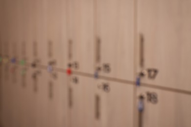 Blurred view of numbered wooden lockers with keys