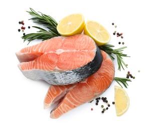 Fresh raw salmon steaks with rosemary, peppercorns and lemon on white background, top view