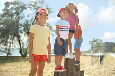 Cute children at outdoor playground on sunny day. Summer camp