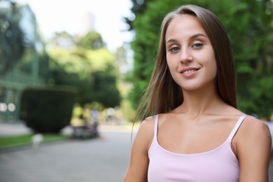 Photo of Portrait of beautiful young woman on city street, space for text