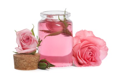 Photo of Bottle of essential rose oil and flowers on white background