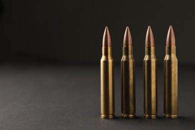 Bullets on black background, closeup. Space for text