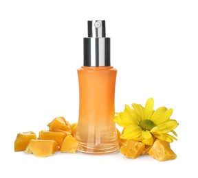 Bottle of cosmetic product, natural beeswax and flower on white background