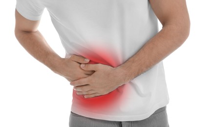 Man suffering from pain in lower right abdomen on white background, closeup. Acute appendicitis