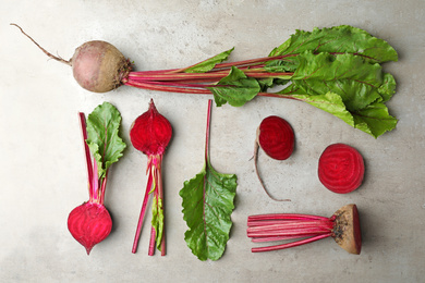 Flat lay composition with raw beets on light grey table