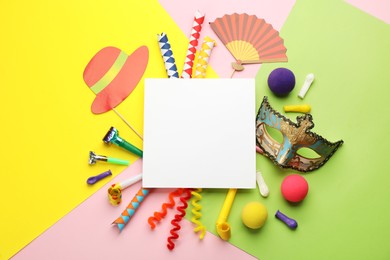 Flat lay composition with carnival items and blank card on color background. Space for text