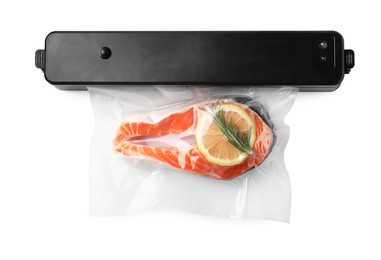 Vacuum packing sealer and plastic bag with salmon on white background, top view