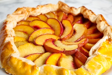 Delicious fresh peach pie on table, closeup