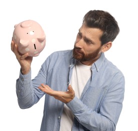 Photo of Man with ceramic piggy bank on white background