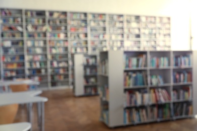 Blurred view of library interior with bookcases and tables