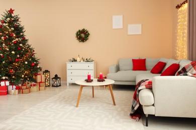 Photo of Christmas interior. Beautiful tree decorated with baubles in room with cozy furniture