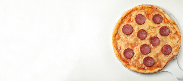 Image of Top view of hot delicious pizza on white table, space for text. Banner design 