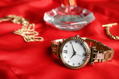 Photo of Luxury wrist watch on red background, closeup