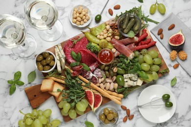 Photo of Set of different delicious appetizers served on white marble table, flat lay