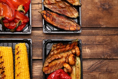 Plastic containers with different grilled meal on wooden table, flat lay. Food delivery service