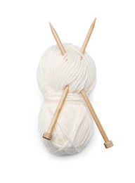 Soft woolen yarn with knitting needles on white background, top view