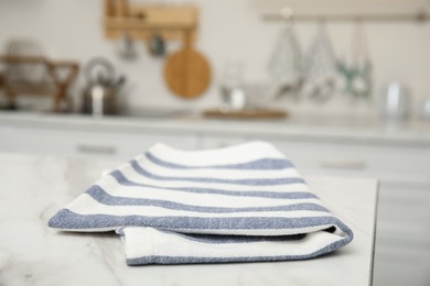Clean towel on white marble countertop in kitchen