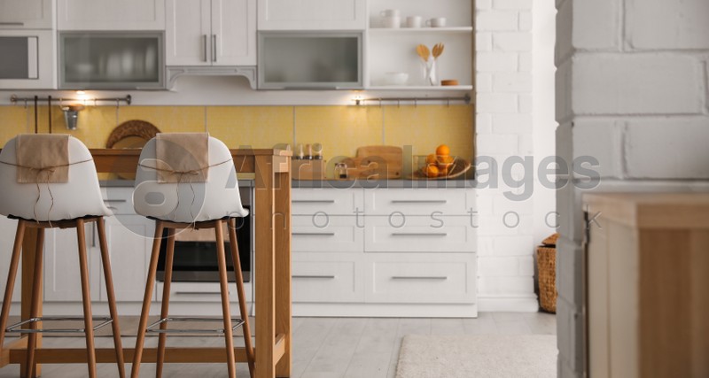 Image of Modern kitchen interior with stylish wooden table. Banner design