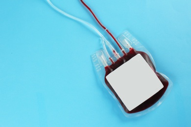 Photo of Blood pack on color background, top view with space for text. Donation day