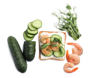 Tasty toast with cream cheese, shrimps, cucumbers and microgreens on white background, top view
