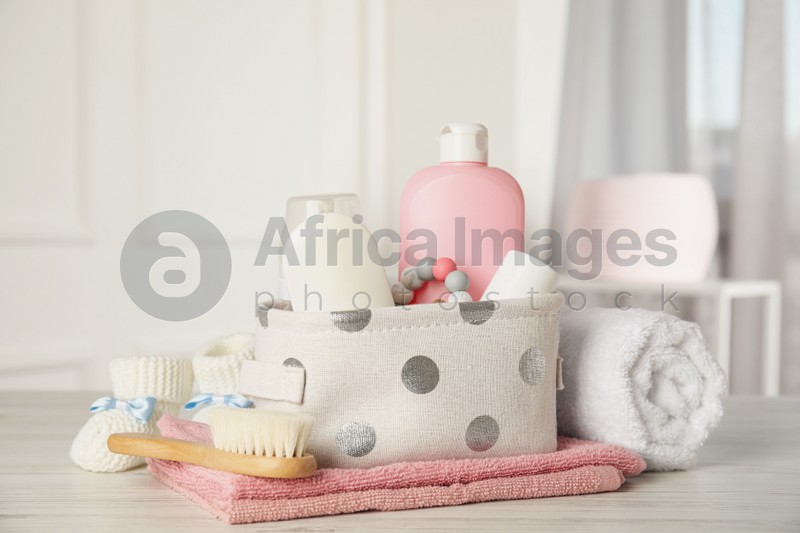 Photo of Baby accessories on white wooden table indoors