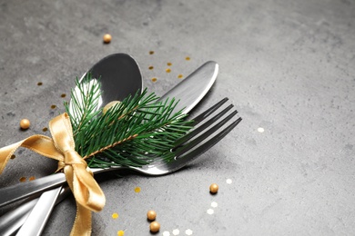 Cutlery set for festive table on grey background, closeup