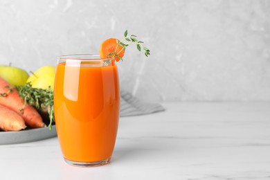 Photo of Glass with healthy carrot juice and ingredients on white table. Space for text