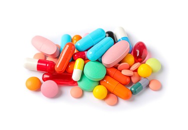 Pile of different colorful pills on white background, above view