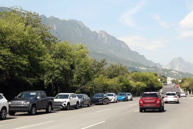 Picturesque view of mountains and highway with cars