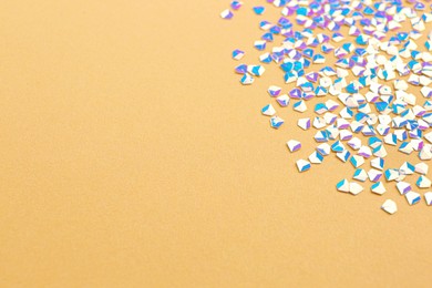 Photo of Shiny bright light blue glitter on beige background. Space for text